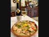 Açorda de Mariscos, a classic Alentejo-style seafood bread stew, where rustic bread is soaked in a fragrant broth of garlic, coriander, olive oil, and shrimp or clams, creating a rich and velvety dish.