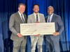 Larry Di Rita, President, Bank of America Greater Washington, D.C. (left) and Steve Boland, Bank of America Chief Administrative Officer (right) present Dan Barker, Halcyon President and Chief Executive Officer, with a Neighborhood Builders grant check