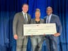 Larry Di Rita, President, Bank of America Greater Washington, D.C. (left) and Steve Boland, Bank of America Chief Administrative Officer (right) present Kimberly D. Gayle, Wacif Co-Interim-Chief Executive Officer, with a Neighborhood Builders grant check