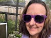 Beckiee Frasca wears purple Shades For Migraine Sunglasses as a symbol of migraine awareness.