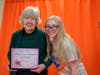 Keystone Villa at Douglassville resident Martha Gentry proudly displays her Wellness Warrior Ambassador Certificate of Achievement from FOX Rehabilitation's FOX Stronger Living program, alongside FOX Rehabilitation exercise physiologist Megan Grace.