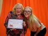 Keystone Villa at Douglassville resident Relda Lockwood proudly displays her Wellness Warrior Ambassador Certificate of Achievement from FOX Rehabilitation's FOX Stronger Living program, alongside FOX Rehabilitation exercise physiologist Megan Grace.