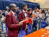 From left, Isaiah Adegoye and Morgan Colvin receive information about the University of Illinois during the Salute to Academic Achievement on September 27.