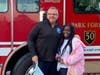 Park Forest Fire Department Chief Tracy Natyshok and Indiana School fifth grader Toni Rogers. Rogers was escorted to school on the fire truck as the winner of the Fire Prevention Week Poster contest. 
