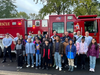 Toni Rogers was greeted by her fifth grade class as she arrived to school on a fire truck.