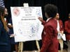 Southland College Prep seniors place stickers on the map to indicate where they will attend college.