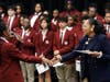 Dr. Blondean Y. Davis congratulates a student during the school’s celebration of its 11th graduating class all being accepted to college.