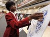Southland senior Jacob Southall places a sticker on the map to show where he plans to attend college.