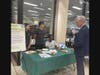 YMCA Teens explaining their PureBin to Mayor Roach at the Earth Day 2025 symposium 