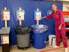 Kirsten Bourne presenting the new four-colored bin system that students are using for the Wasteless Horsemen initiative.