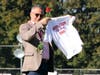 Superintendent Dr. Sanchez receives a rose and T-shirt during the ceremony as the students welcome him into the district.