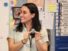 Viola Santelia-Miculcy proudly shows off her challenge coin to her students.