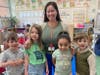 A teacher and students wear green to support Mental Health Awareness.
