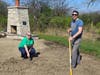 Raking out the small weeds to refresh the stone
