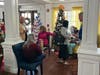 Multiple decorated trees create a magical holiday scene in Lake Forest Park's community space during the Festival of Lights celebration.