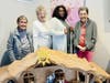 Residents gather around a detailed nativity scene during Bible Study in the Independent Living community, sharing moments of spiritual reflection and fellowship.