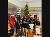 Members of Jaleel Court 242 gather with children by the Christmas tree after their generous sock drive benefiting Lake Forest Park's Assisted Living residents.