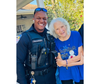 A police officer and resident share a joyful moment, exemplifying the day’s success in bringing together law enforcement and community members.