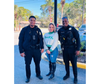 Local police officers take time to connect with staff members, demonstrating the event’s impact on all levels of the community.