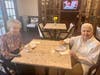 Joan Stack and Inez Grosso share smiles, and a sweet treat, at the newly opened William Pitt Cafe, a now favorite spot for Juniper residents!