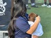 Young Lady from Place of Hope Bonds and Cuddles with a Big Dog Ranch Rescue Puppy after Giving him a Christmas Bath