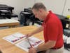 K12 President John Kilburg prepares to print letters written by children thanking their parents for their Christmas gifts.