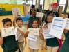 Roseville's well-traveled scholars show off their passport stamps after arriving safely back home at "the RCCS International Airport".