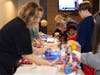 Lion Volunteer help wrap presents 