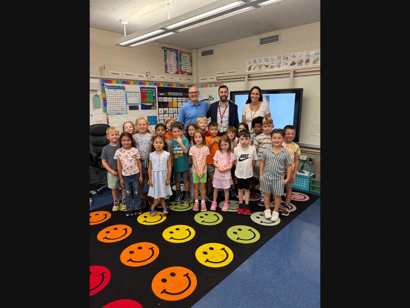 Tiskio Principal James O'Connor, Branford Public Schools Chief Operating Officer Blaize Levitan, and teacher Christine Bonatti and her first grade class.