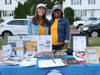 Pictured (left to right) are Nicole Osborne and Vitalie Memeus managing the SCI table, where free Woburn Juneteenth t-shirts and CDs of local bands were distributed.  