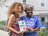 Juneteenth Woburn 2026 Keynote Speaker Malia Lazu (left) with Library Director Hermayne Gordon (right) holding Lazu’s new book, From Intention to Impact.
