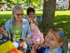Asher Reiner could not be happier as Judy Hirt-Manheimer of the Enchanted Garden adds the final touches to a rainbow while Eleanor Manheimer looks on.
