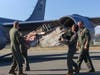 Air National Guard officers from Wisconsin carrying the wing part from Major Richard Bong’s World War II P-38 plane.