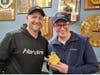Jeffrey Enchura, right, with gold medalist John Shuster