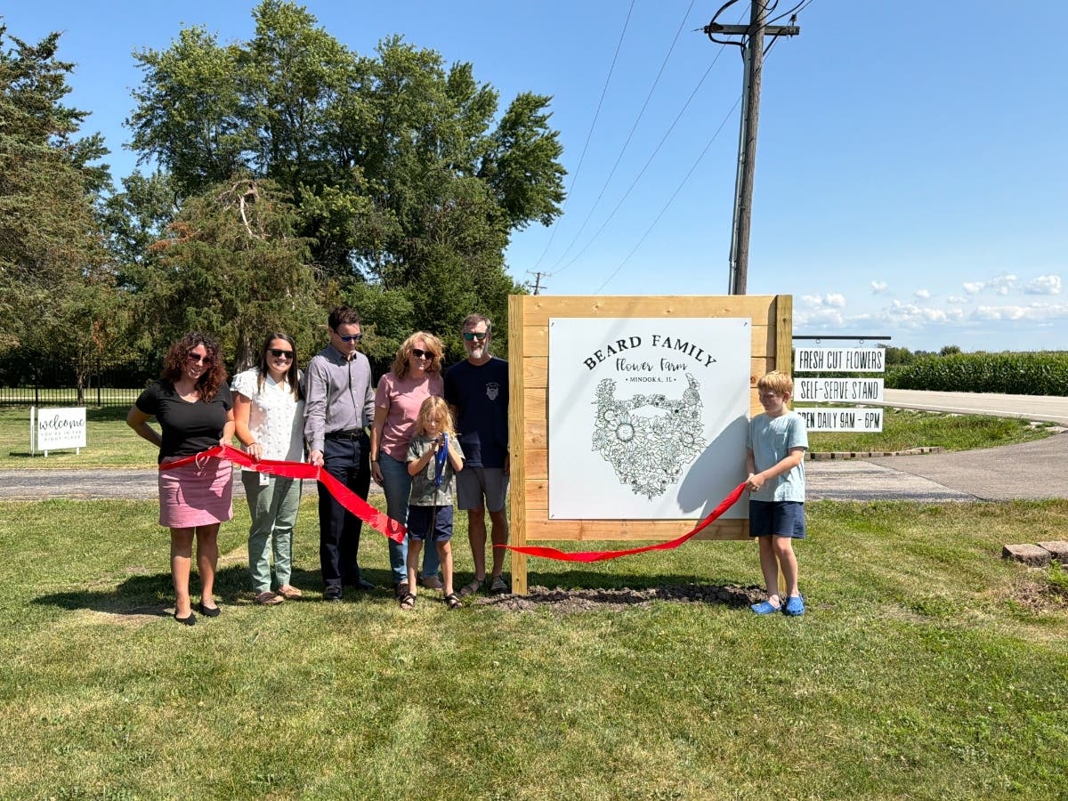 Lisa Beard and her family celebrate their new business with a Channahon Minooka/Grundy Chamber ribbon cutting.