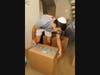 Johnny's Giving Kitchen committee member packing boxes