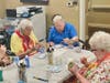 Residents focused on painting light-up lighthouse mason jars! 