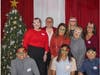 Associates wear festive glasses as they pose for a fun holiday photo. 