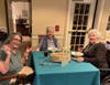 Residents enjoy an elegant dining experience at a beautifully set table during the special fine dining event.