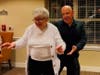 The "USO Sweethearts Dance" brings joy and romance as residents enjoy swing dance lessons led by Oscar from Havana Dance Center, accompanied by Leonardo Performances' energetic DJ sets.