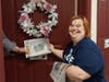 A small gesture makes a big impact as Rachel delivers a newspaper to a Juniper Village at Mount Joy resident.