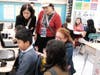 Educators visit a 5th-grade ELA classroom.
