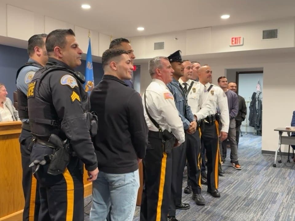 Officer Yovani Lopez with members of the Freehold Borough Police Department and Borough Council.