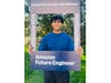 Gedipudi with a sign for 2026 Amazon Future Engineer Scholarship winners.