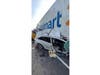 The car trapped beneath the Walmart truck.