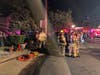 Firefighters gathering outside the home.