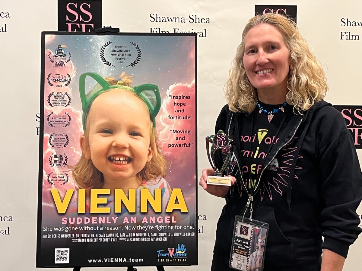 Dr. Wunderler with a poster for "VIENNA: Suddenly An Angel."