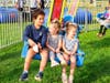 Kids on a carnival ride at SukkahFest.