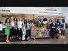 Ginny Hill, CEO and Girl Scouts of Troop 30077 present Girl Scout Cookies to representatives of the Cooper Foundation and other healthcare heros.