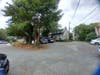 This gray house, which is currently up for residential lease, has virtually no buffer at all between its lot and the proposed development. Tenants would see a huge four story building directly from their back yard.